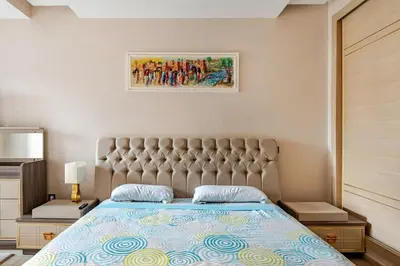 a bedroom with a bed with a tufted headboard at Cosy 2 Bedrooms Skhirat Residence in Skhirat