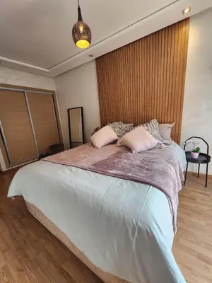 a bedroom with a large bed with two pillows at Modern Studio Panoramic View with Wi-Fi et Parking in LʼOasis