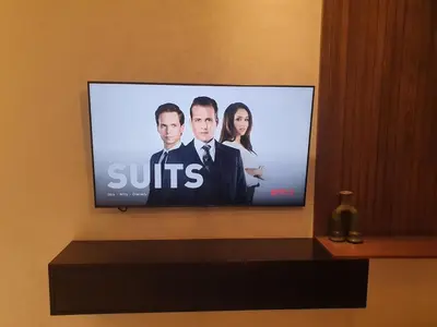a flat screen tv on a wall in a room at Modern Studio Panoramic View with Wi-Fi et Parking in LʼOasis