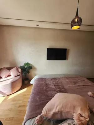 a bedroom with a bed and a flat screen tv at Modern Studio Panoramic View with Wi-Fi et Parking in LʼOasis