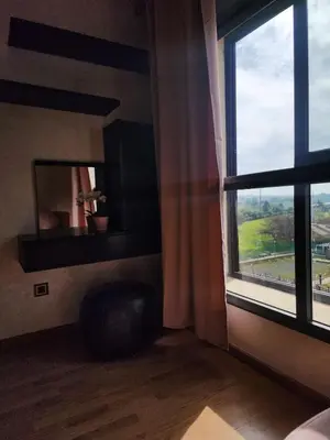 a room with a large window with a chair and a table at Modern Studio Panoramic View with Wi-Fi et Parking in LʼOasis