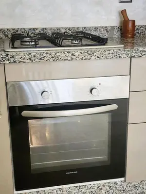 a stove top oven sitting in a kitchen at Modern Studio Panoramic View with Wi-Fi et Parking in LʼOasis
