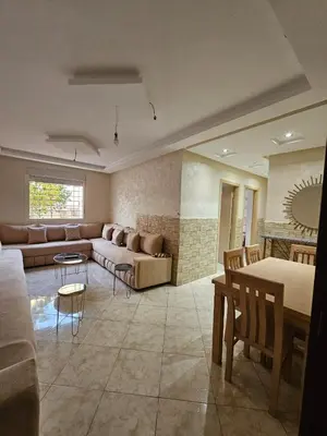 a living room with a couch and a table at Bouznika in Bouznika