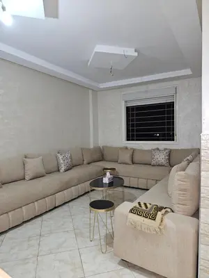 a living room with a couch and a table at Bouznika in Bouznika