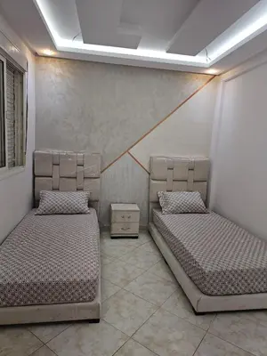 a room with two beds in a room at Bouznika in Bouznika