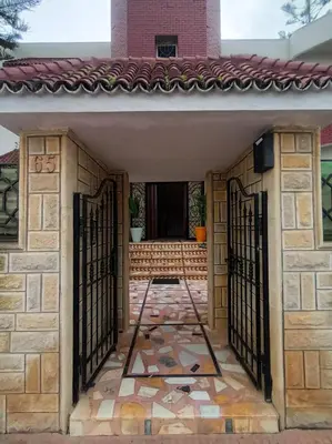 an entrance to a house with wrought iron gates at Villa stade Moulay Abdellah in Temara