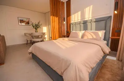 a bedroom with a large bed and a table at Studio 09 Maarif - High Speed Wi-Fi in Casablanca