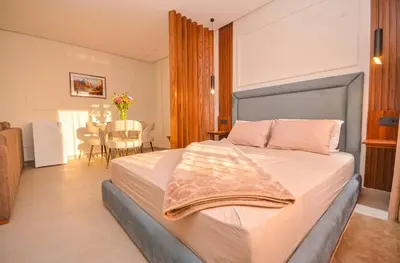 a bedroom with a large bed and a dining room at Studio 09 Maarif - High Speed Wi-Fi in Casablanca