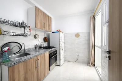 a small kitchen with a sink and a refrigerator at Appartement Bouskoura 15 min de l'aéroport mohamed 5 in Casablanca