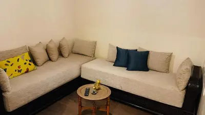 a living room with two couches and a table at Bright and cozy studio in Tamaris Beach in Tamaris