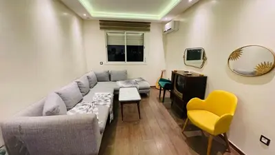 a living room with a couch and a yellow chair at Bright and cozy studio in Tamaris Beach in Tamaris