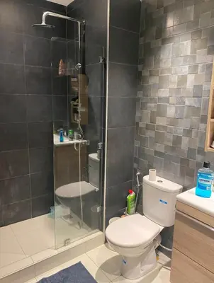 a bathroom with a toilet and a glass shower at Bright and cozy studio in Tamaris Beach in Tamaris