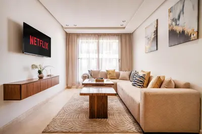 a living room with a couch and a table at Maarif Premium 2 Bedrooms 2 Bathrooms La Reine II in Casablanca