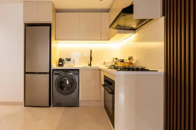 a kitchen with a washing machine and a washer at Maarif Premium 2 Bedrooms 2 Bathrooms La Reine II in Casablanca