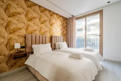 two beds in a bedroom with a wall mural at Maarif Premium 2 Bedrooms 2 Bathrooms La Reine II in Casablanca