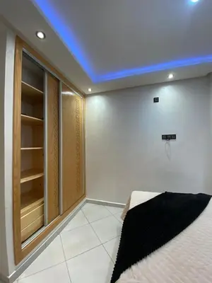 a room with a bed and a blue ceiling at Apartment in Bouznika with pool in Bouznika