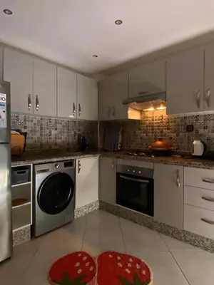 a kitchen with a stove and a dishwasher at Apartment in Bouznika with pool in Bouznika