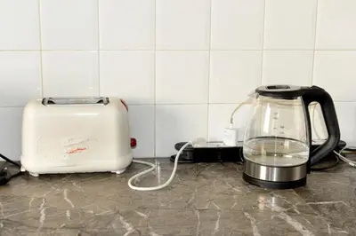a kitchen counter with a blender and a toaster at Appartement familial convivial in Rabat