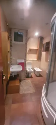 a bathroom with two toilets and a sink and a mirror at Grand appartement avec une belle vue in Rabat