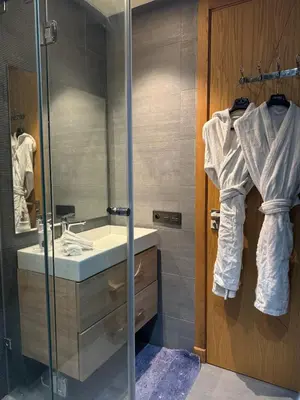 a bathroom with a sink and a shower with a mirror at Séjour Premium Casablanca in LʼOasis