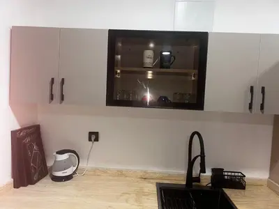 a kitchen with a microwave above a kitchen counter at Olive & Orange Modern Studio in Rabat