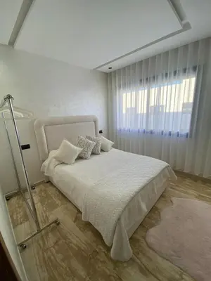a bedroom with a white bed with a window at Le Miroir in Casablanca