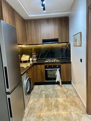 a kitchen with a refrigerator and a dishwasher at Le Miroir in Casablanca