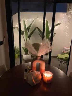 a vase with feathers and candles on a table at Le Miroir in Casablanca