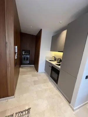a small kitchen with a sink and a stove at Suite Cozy Design Suite Maarif, Close to Ain Diab in Casablanca