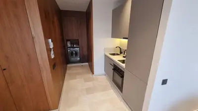 a kitchen with a sink and a washing machine at Suite Cozy Design Suite Maarif, Close to Ain Diab in Casablanca