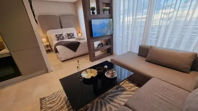 a living room with a couch and a table at Suite Cozy Design Suite Maarif, Close to Ain Diab in Casablanca