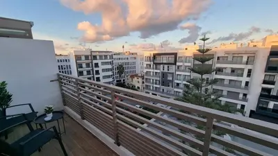 a balcony with a view of a city with buildings at Suite Cozy Design Suite Maarif, Close to Ain Diab in Casablanca