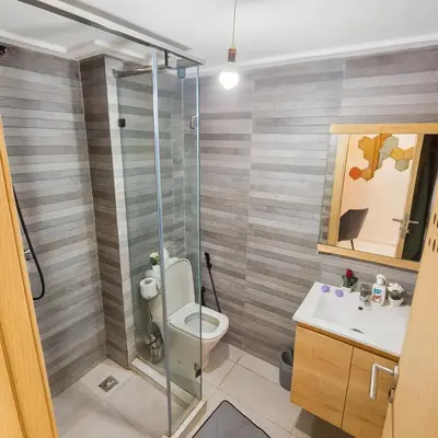 a bathroom with a toilet and a sink at Vue Piscine Idéal pour Supporters Transfert in Mansouria
