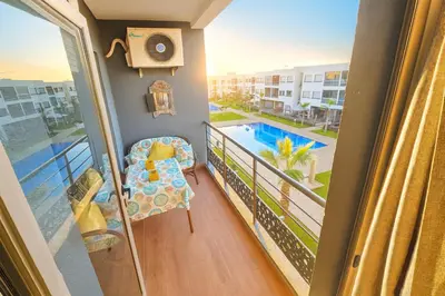 a balcony with a chair and a view of a pool at Vue Piscine Idéal pour Supporters Transfert in Mansouria