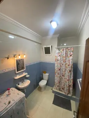 a blue bathroom with a toilet and a sink at Charming Apartment in Temara Near Beach & Rabat in Temara