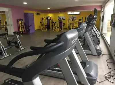 a gym with a row of tread machines at La Siesta Beach Appartement in Mohammedia