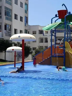 a group of people playing in a swimming pool at La Siesta Beach Appartement in Mohammedia