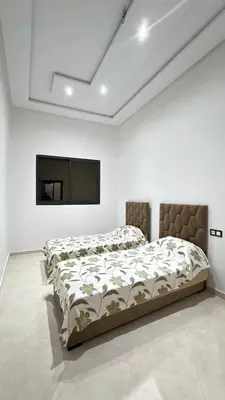 a bedroom with a bed and a flat screen tv at Nice apartment in temara-a in Temara
