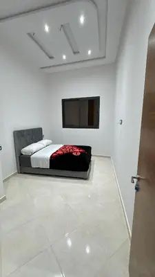 a bedroom with a bed and a flat screen tv at Nice apartment in temara-a in Temara