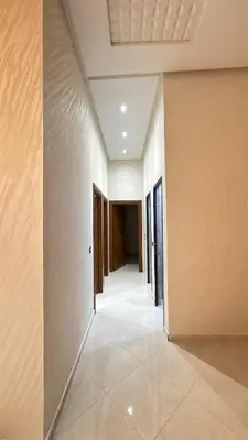 an empty hallway of a house with white walls at Nice apartment in temara-a in Temara
