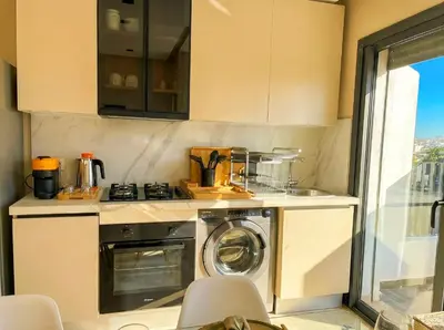 a kitchen with a washing machine and a sink at Maya Suites - Habous Old Town - Panoramic City View in Casablanca