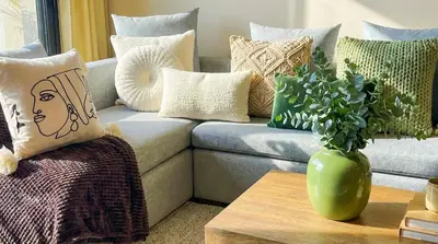 a couch with pillows and a vase on a table at Maya Suites - Habous Old Town - Panoramic City View in Casablanca
