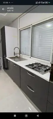 a kitchen with a stove and a sink and a window at Temara wifak in Temara