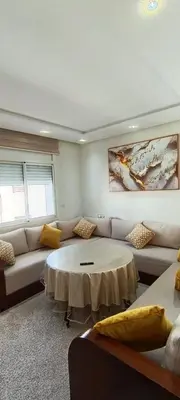 a living room with a couch and a table at Temara wifak in Temara