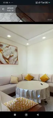 a living room with a table and a couch at Samir in Temara