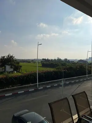 a view of a road with chairs and a street light at Costa in Bouznika