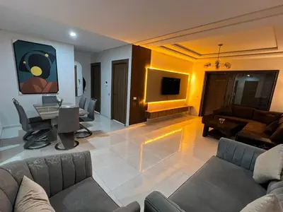 a living room with a couch and a table at Costa in Bouznika