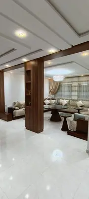 a living room with couches and tables in a room at Temara wifak in Temara