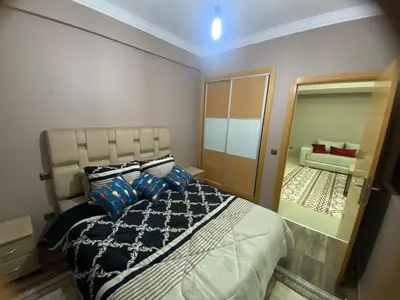 a bedroom with a large bed and a mirror at Casablanca Comfortable City-Centre Apartment in Casablanca