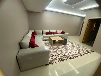 a living room with a couch and a coffee table at Casablanca Comfortable City-Centre Apartment in Casablanca